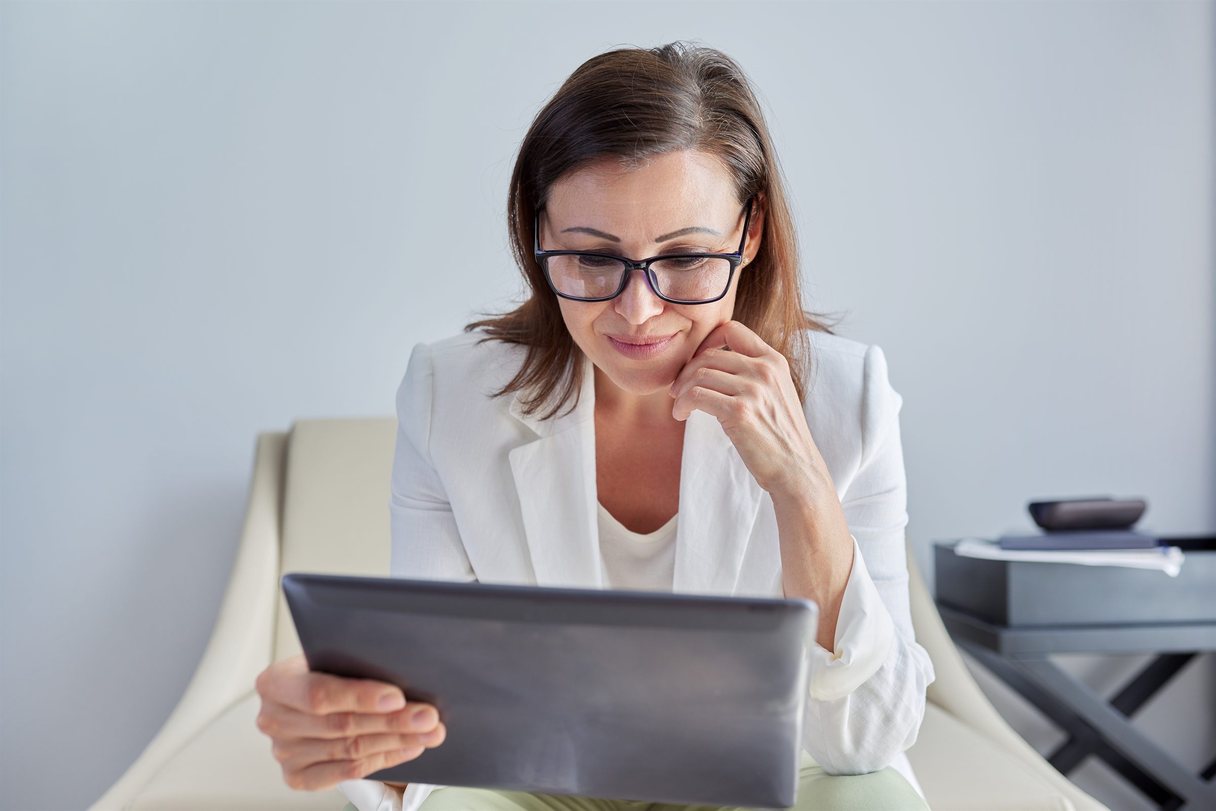 Psychologist reviewing session notes on a tablet